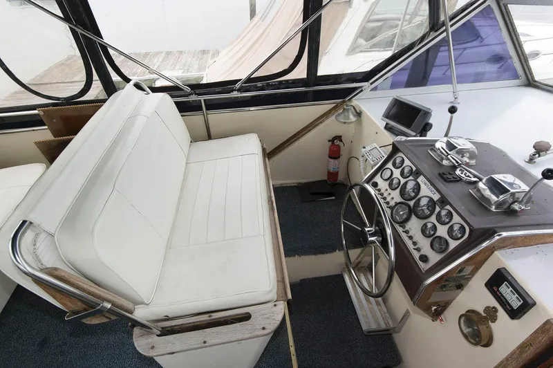 Slide: The Image of 1984 Chris-Craft 350 Catalina helm with white seating and classic instrument panel. - 6