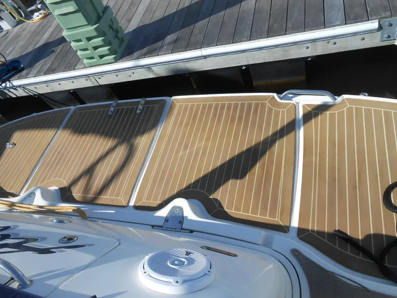 Slide: The Image of 2005 Sea Ray 420 Sundancer swim platform with teak decking at a dock. - 10