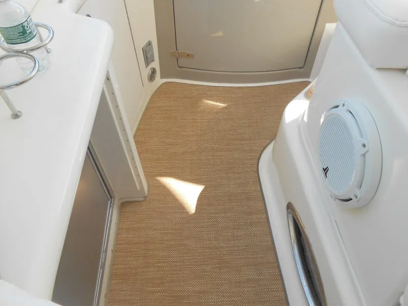 Slide: The Image of 2005 Sea Ray 420 Sundancer interior with beige carpet and white seating. - 11