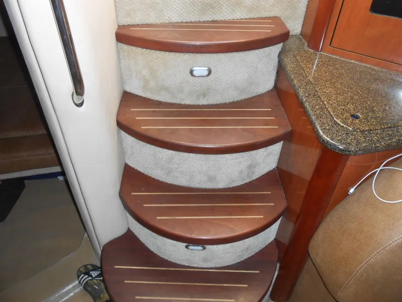 Slide: The Image of Staircase inside 2005 Sea Ray 420 Sundancer yacht with wooden steps and carpeted risers. - 12