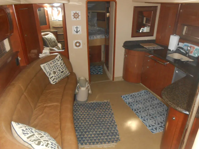 Slide: The Image of Interior of 2005 Sea Ray 420 Sundancer yacht with cozy seating and modern kitchen area. - 13