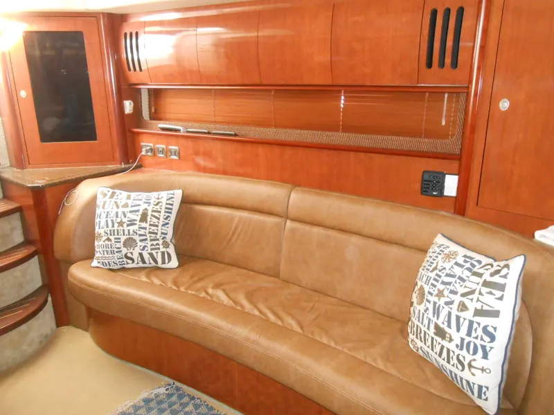 Slide: The Image of Luxurious interior of 2005 Sea Ray 420 Sundancer with leather seating and decorative pillows. - 16