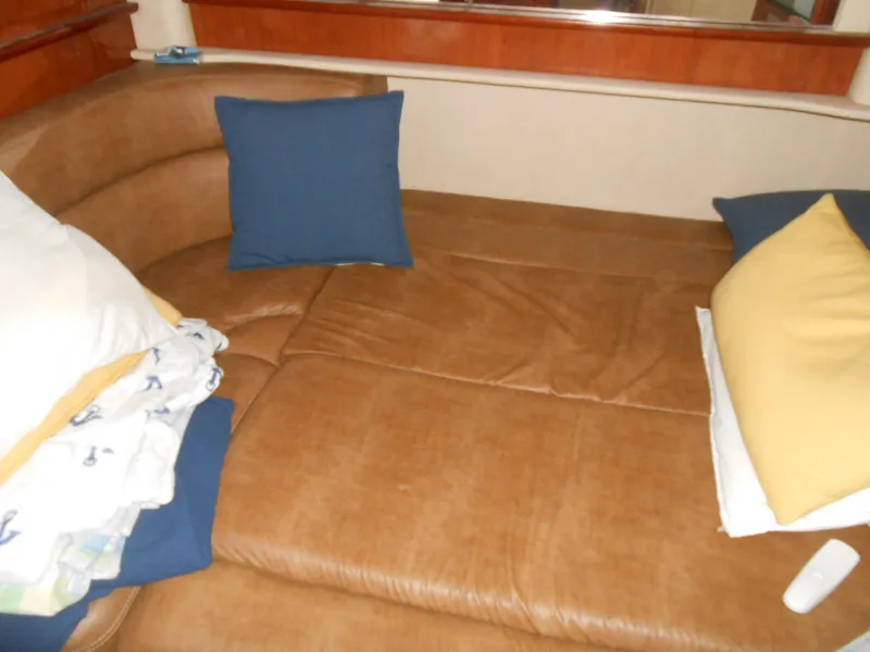 Slide: The Image of Interior seating area of a 2005 Sea Ray 420 Sundancer with cushions and pillows. - 19
