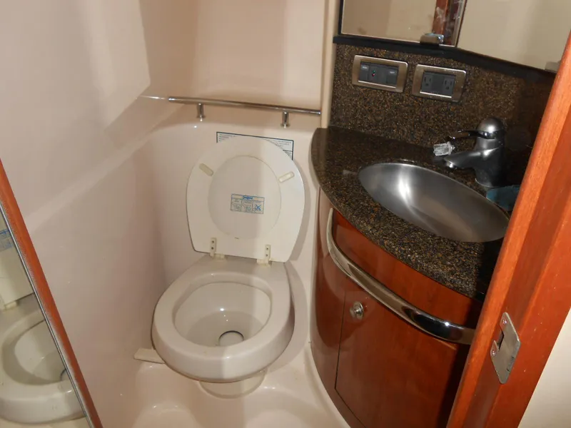 Slide: The Image of Bathroom interior of 2005 Sea Ray 420 Sundancer yacht, featuring toilet and sink. - 21