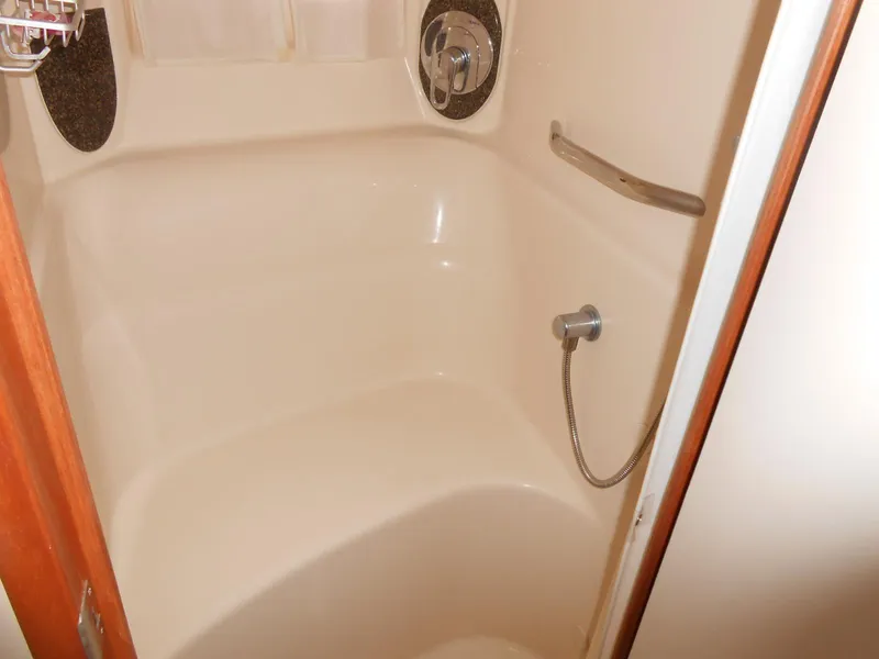 Slide: The Image of 2005 Sea Ray 420 Sundancer shower interior with handheld showerhead and grab bar. - 22