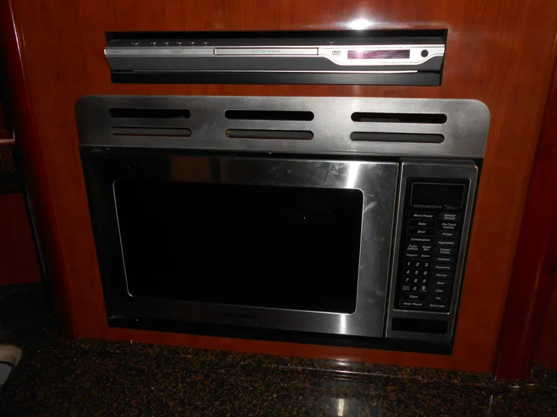 Slide: The Image of Built-in microwave and DVD player in 2005 Sea Ray 420 Sundancer yacht kitchen. - 23
