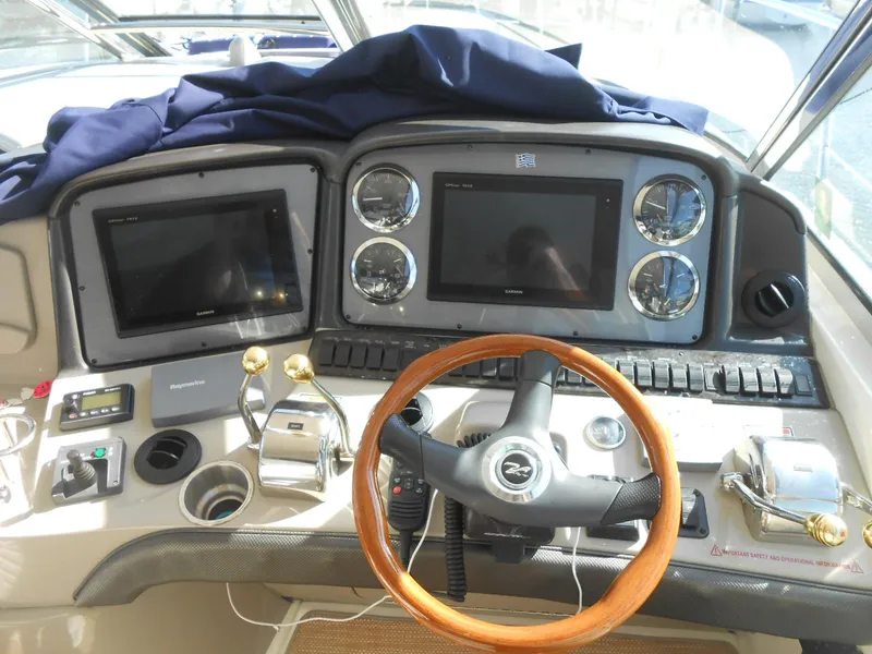 Slide: The Image of Helm of 2005 Sea Ray 420 Sundancer with dual screens and wooden steering wheel. - 26