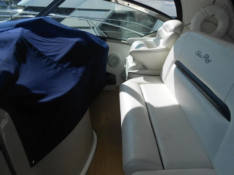 Slide: The Image of Interior of 2005 Sea Ray 420 Sundancer yacht with white seating and covered equipment. - 29