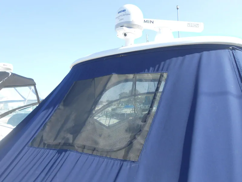 Slide: The Image of 2005 Sea Ray 420 Sundancer with blue canvas cover and radar equipment. - 33