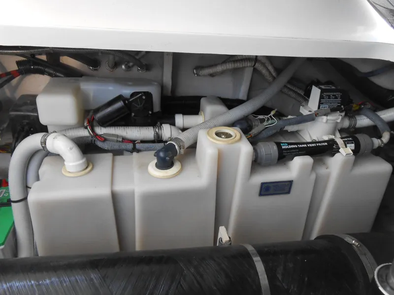 Slide: The Image of Engine compartment of a 2005 Sea Ray 420 Sundancer, showcasing plumbing and mechanical components. - 37