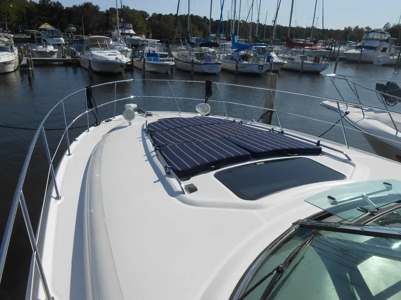 Slide: The Image of 2005 Sea Ray 420 Sundancer yacht docked at a marina with other boats. - 4