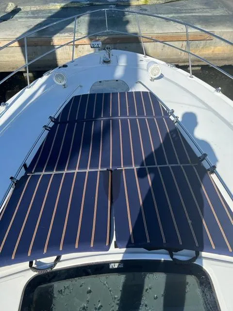 Slide: The Image of 2005 Sea Ray 420 Sundancer bow with striped sun pads. - 47