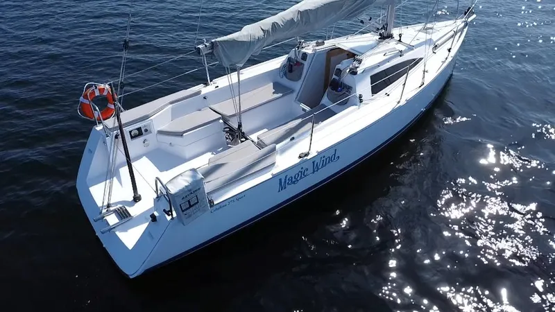 Slide: The Image of 2015 Catalina 275 Sport sailboat on calm water, featuring sleek design and spacious deck. - 1