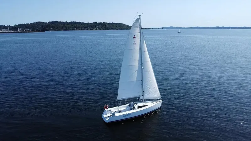 Slide: The Image of 2015 Catalina 275 Sport sailboat cruising on calm waters under clear skies. - 9