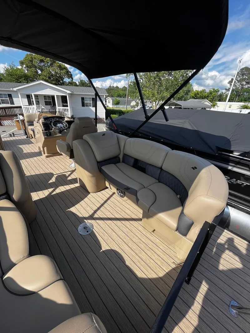 Slide: The Image of 2024 Starcraft SLS 3 pontoon boat with beige seating and canopy. - 15