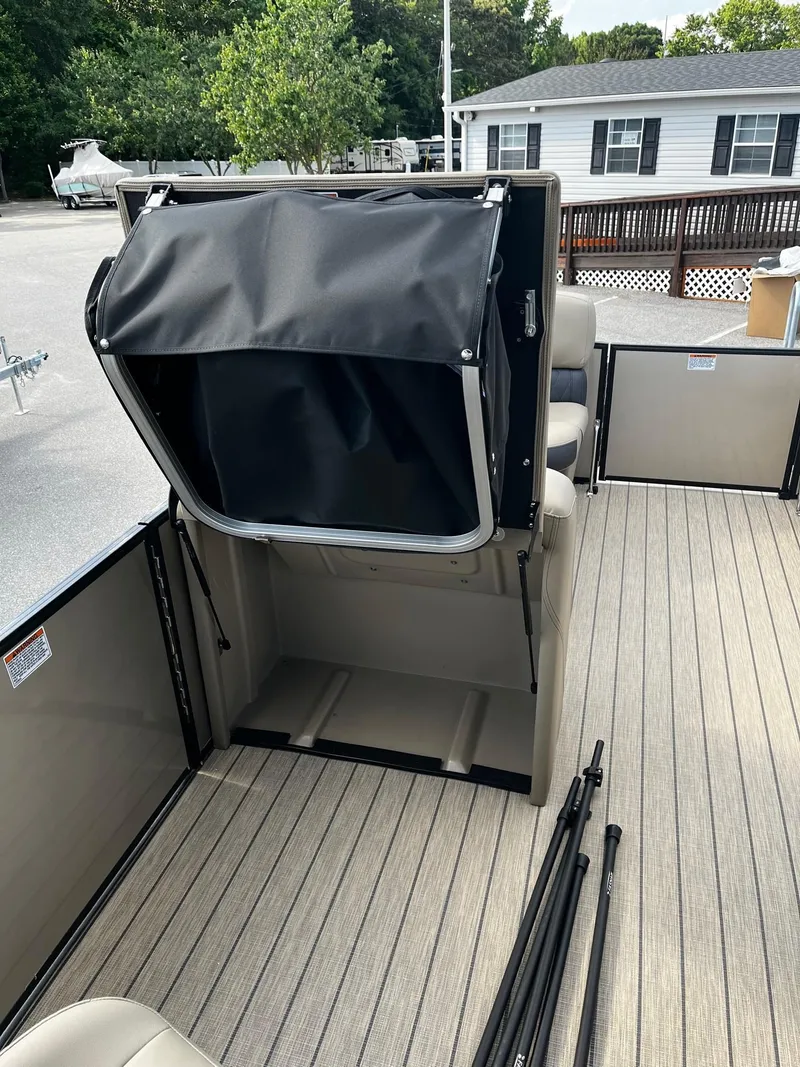 Slide: The Image of 2024 Starcraft SLS 3 pontoon boat interior with open storage compartment. - 9