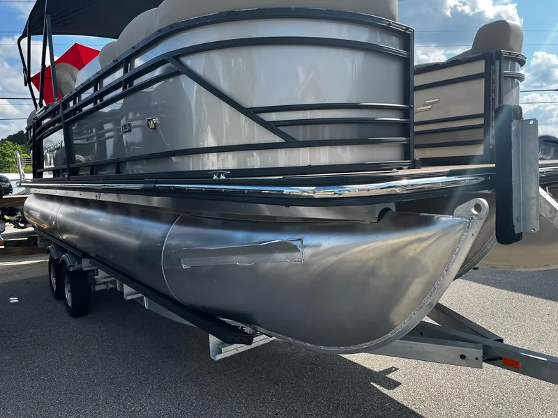 Slide: The Image of 2024 Starcraft SLS 3 pontoon boat on a trailer, side view. - 1
