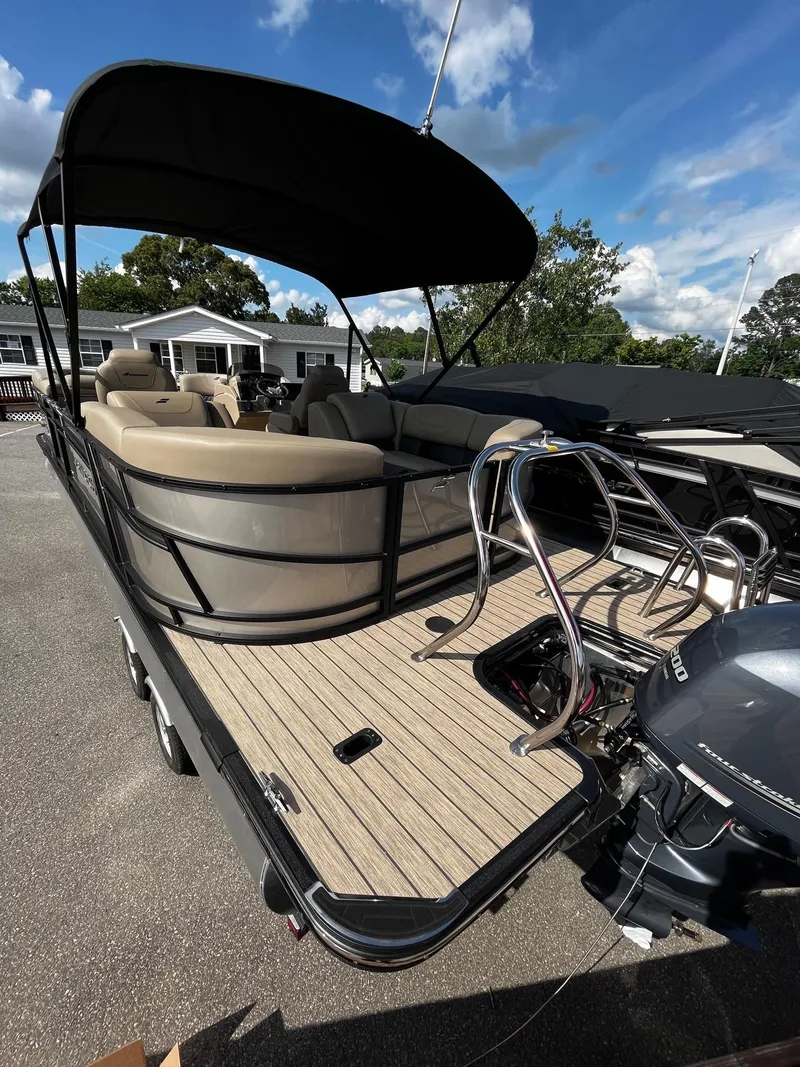 Slide: The Image of 2024 Starcraft SLS 3 pontoon boat with seating and outboard motor. - 5