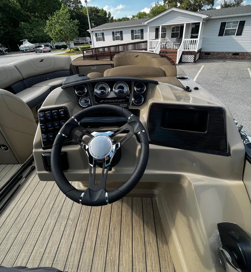 Slide: The Image of 2024 Starcraft SLS 3 boat dashboard with steering wheel and control panel. - 6