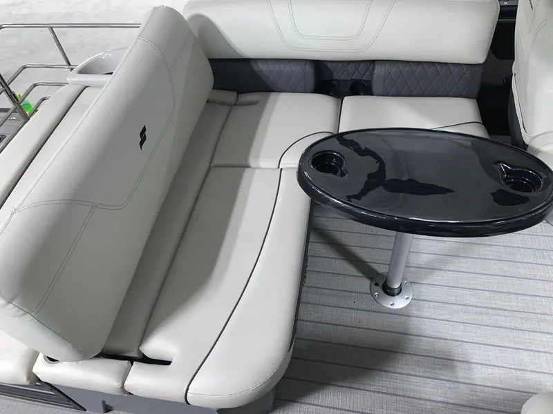 Slide: The Image of 2024 Starcraft SLS 3 Q DH boat interior with plush seating and sleek black table. - 5