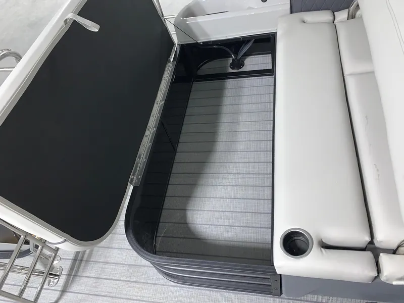 Slide: The Image of 2024 Starcraft SLS 3 Q DH boat storage compartment with cushioned seating. - 3