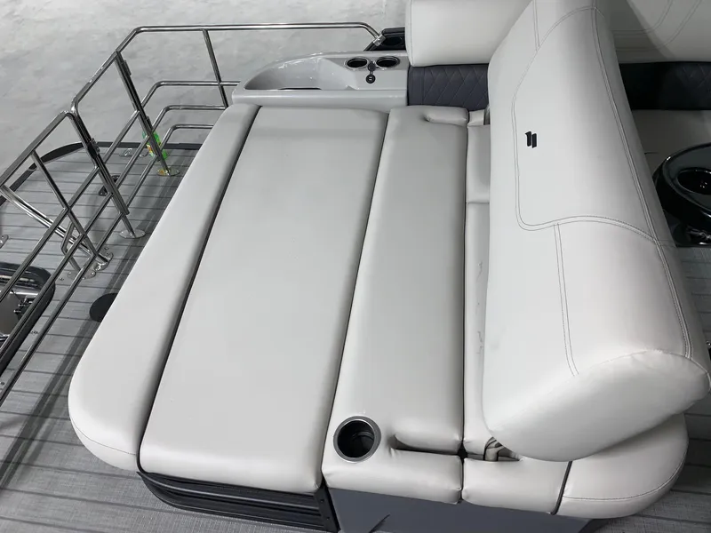 Slide: The Image of 2024 Starcraft SLS 3 Q DH boat with white cushioned seating and stainless steel railings. - 5