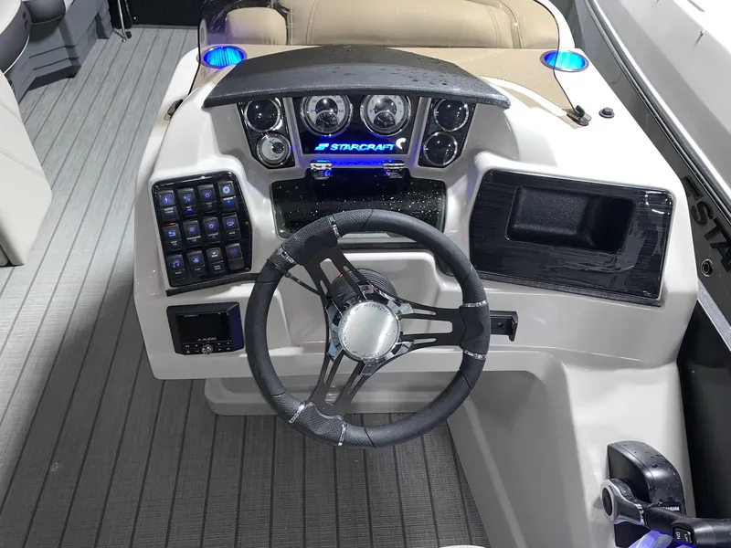 Slide: The Image of 2024 Starcraft SLS 3 Q DH boat dashboard with steering wheel and control panel. - 7