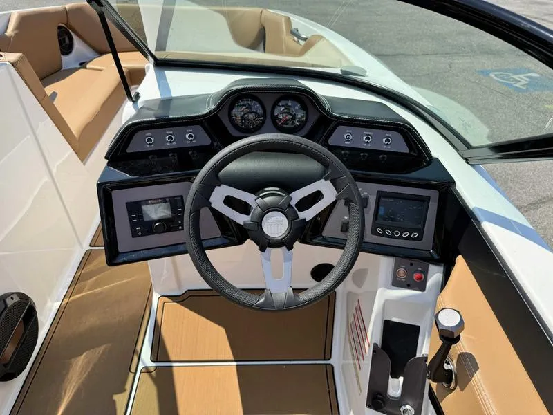 Slide: The Image of 2021 MasterCraft NXT24 boat dashboard with steering wheel and control panel. - 10