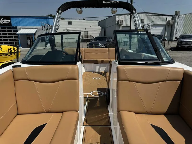 Slide: The Image of 2021 MasterCraft NXT24 boat interior with tan leather seats and open windshield. - 11