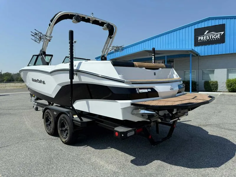Slide: The Image of 2021 MasterCraft NXT24 boat on trailer outside Prestige dealership. - 3