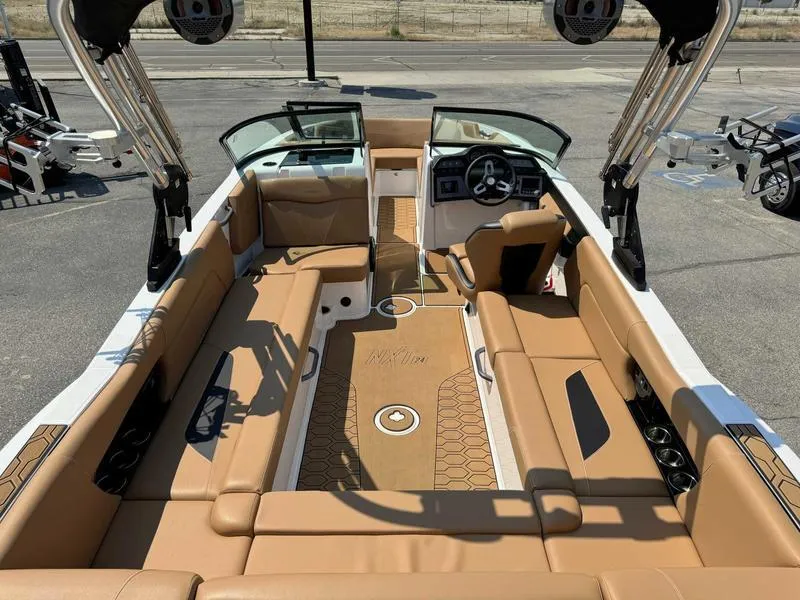 Slide: The Image of 2021 MasterCraft NXT24 boat interior with tan seating and modern dashboard. - 4