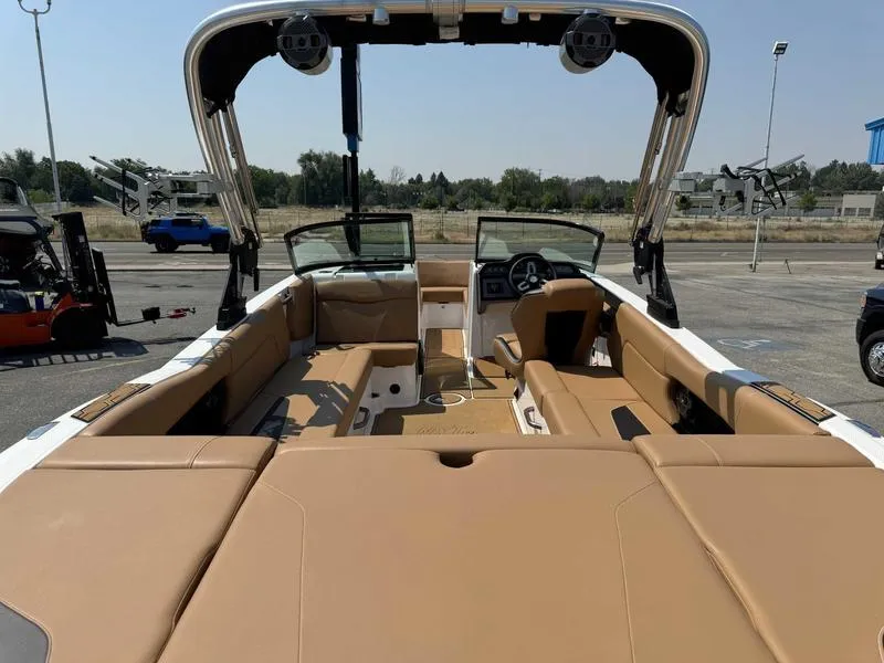 Slide: The Image of 2021 MasterCraft NXT24 boat interior with tan seating and modern dashboard. - 5