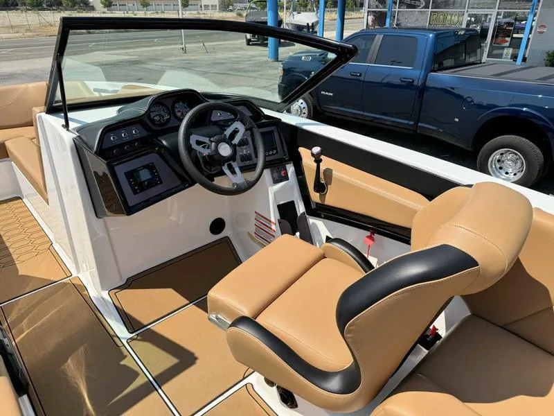 Slide: The Image of 2021 MasterCraft NXT24 boat interior with tan seats and modern dashboard. - 8