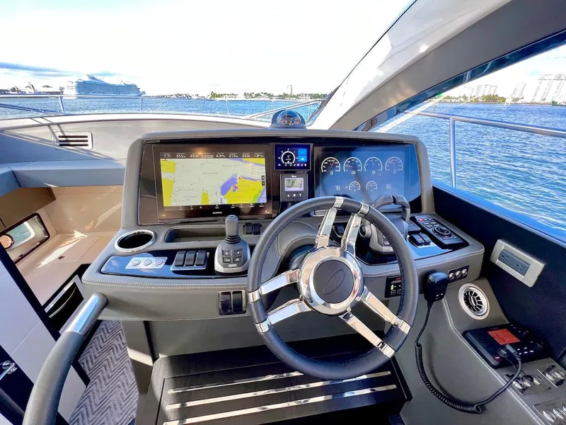 Slide: The Image of Schaefer 510 Sport 2025 yacht cockpit with advanced navigation system and steering wheel. - 15