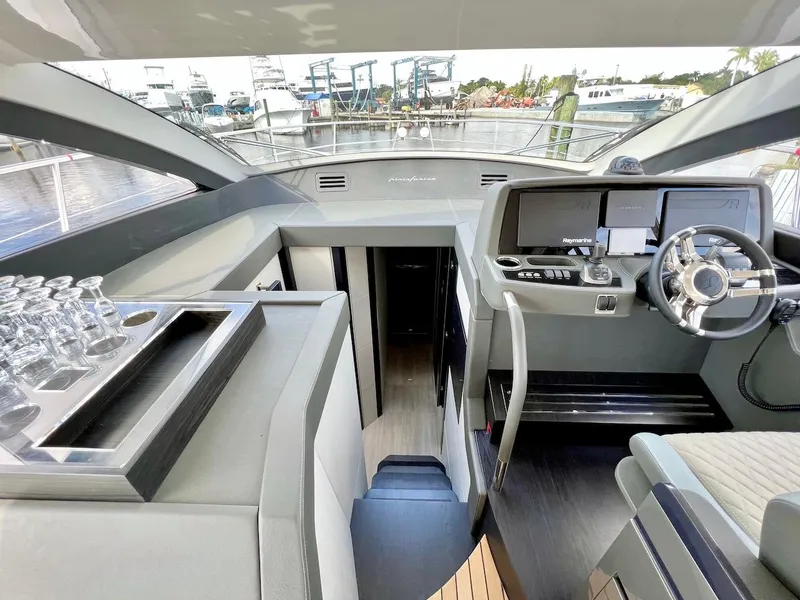 Slide: The Image of Interior of 2025 Schaefer 510 Sport yacht with modern helm and glassware. - 17