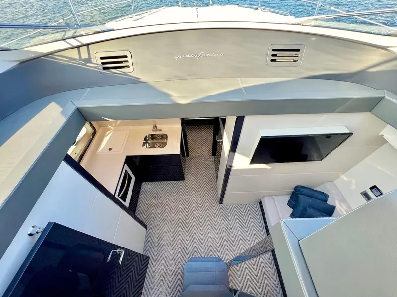 Slide: The Image of Interior of 2025 Schaefer 510 Sport yacht with modern kitchen and cozy seating area. - 18