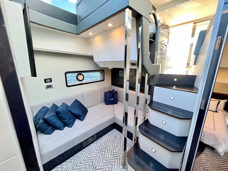 Slide: The Image of Interior of 2025 Schaefer 510 Sport yacht with modern seating and stylish staircase. - 20
