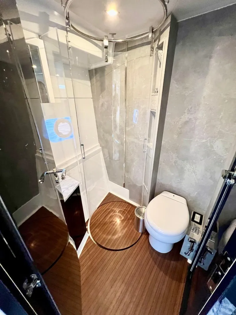 Slide: The Image of Modern bathroom in 2025 Schaefer 510 Sport yacht with glass shower and wooden floor. - 26