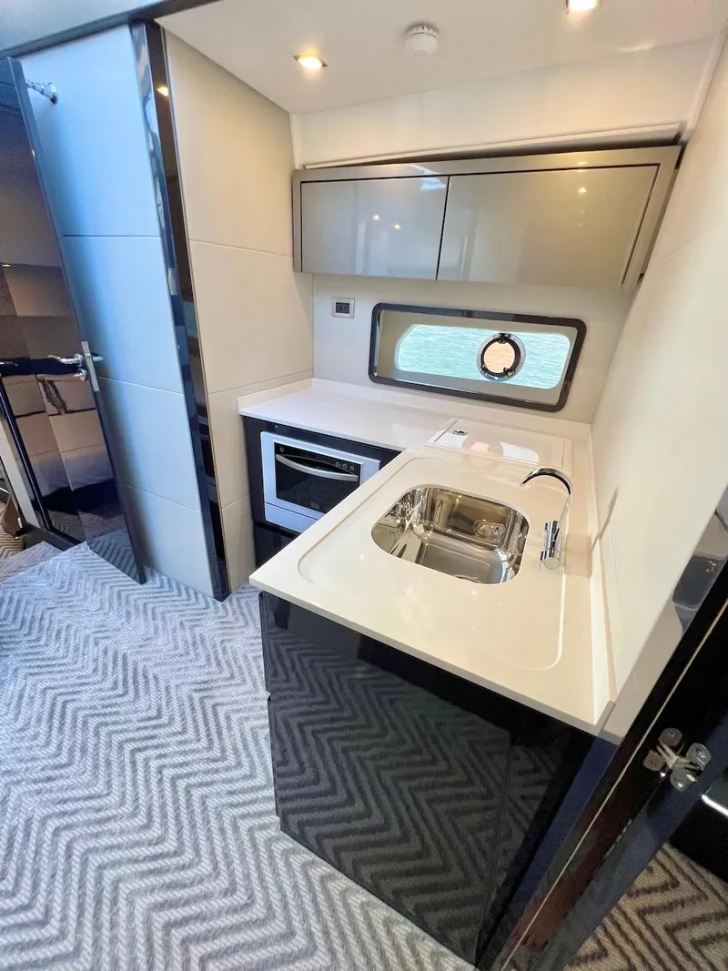 Slide: The Image of Modern kitchen area in 2025 Schaefer 510 Sport yacht with sleek cabinetry and compact appliances. - 28