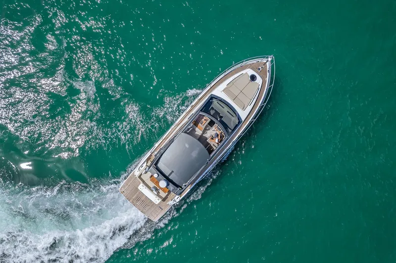 Slide: The Image of Aerial view of 2025 Schaefer 510 Sport yacht cruising on turquoise water. - 3