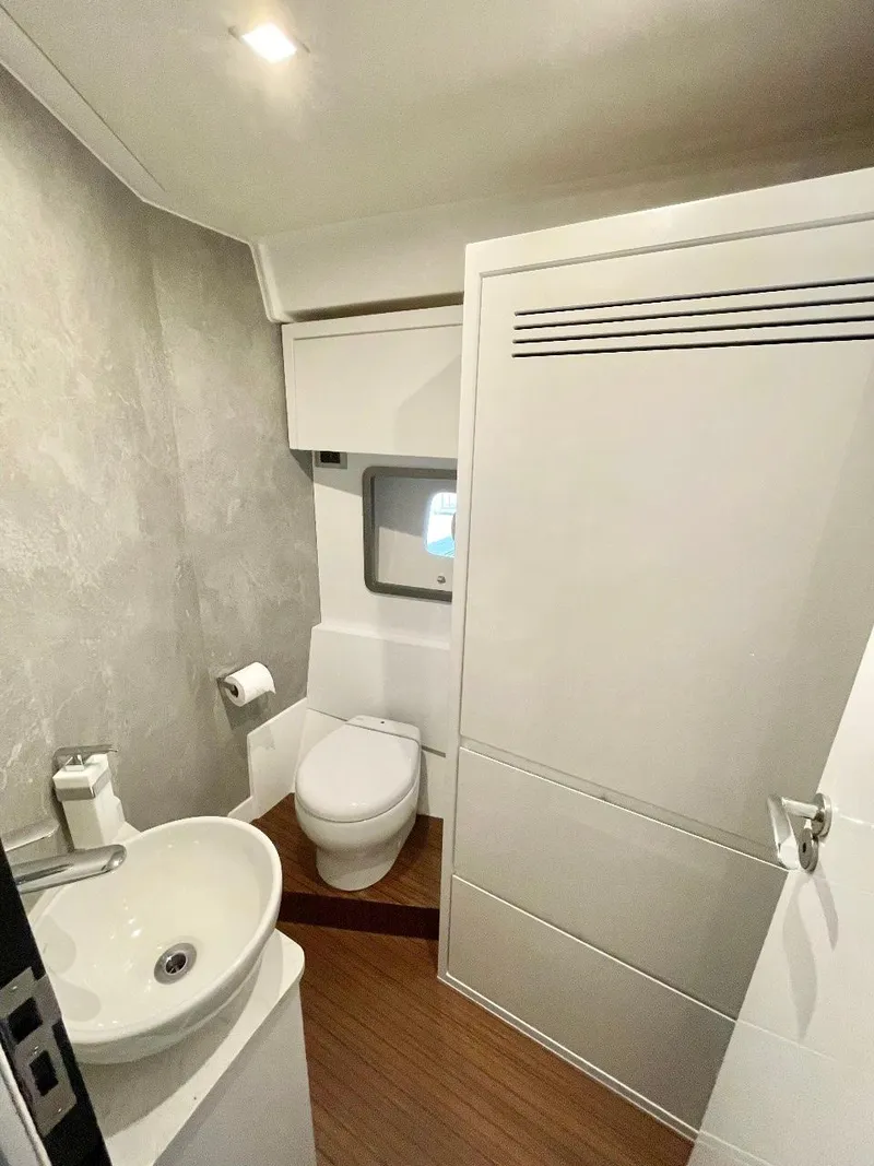 Slide: The Image of Modern bathroom in 2025 Schaefer 510 Sport yacht with sink, toilet, and wooden flooring. - 31