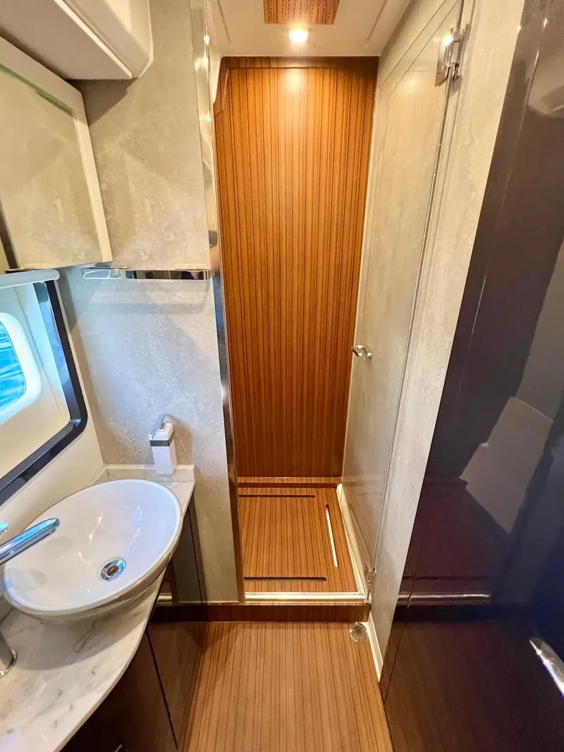 Slide: The Image of Modern bathroom in 2025 Schaefer 510 Sport yacht with wooden accents and sleek fixtures. - 37