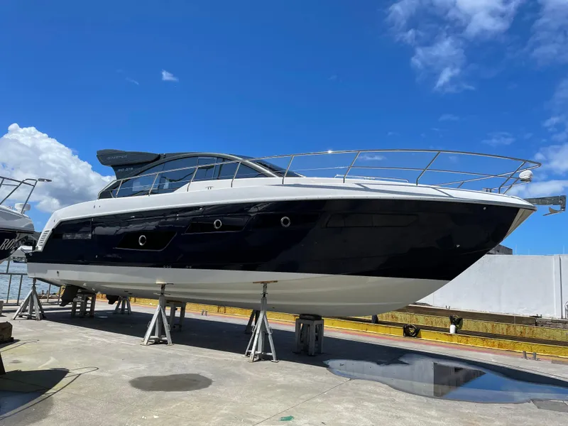 Slide: The Image of Schaefer 510 Sport 2025 yacht on dry dock under clear blue sky. - 40