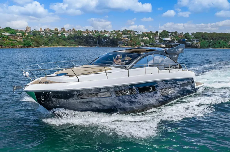 Slide: The Image of 2025 Schaefer 510 Sport yacht cruising on a scenic waterway. - 6