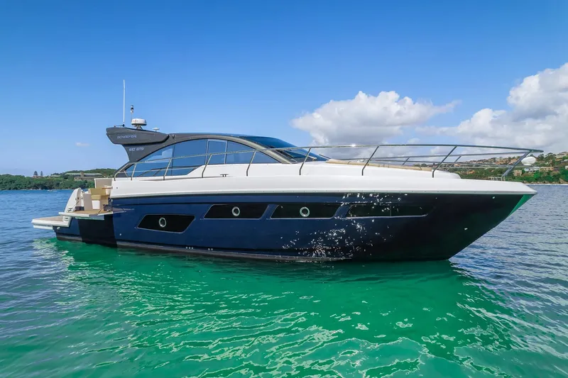 Slide: The Image of 2025 Schaefer 510 Sport yacht on clear turquoise water. - 7