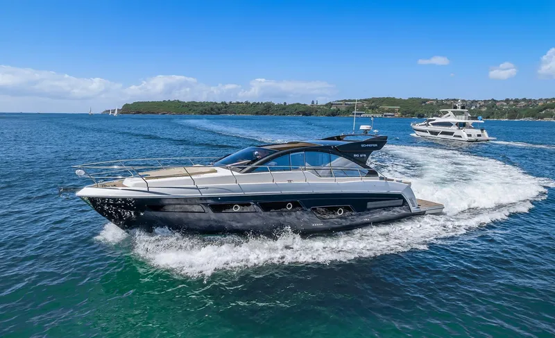 Slide: The Image of Schaefer 510 Sport 2025 yacht cruising on blue waters with scenic coastline. - 9