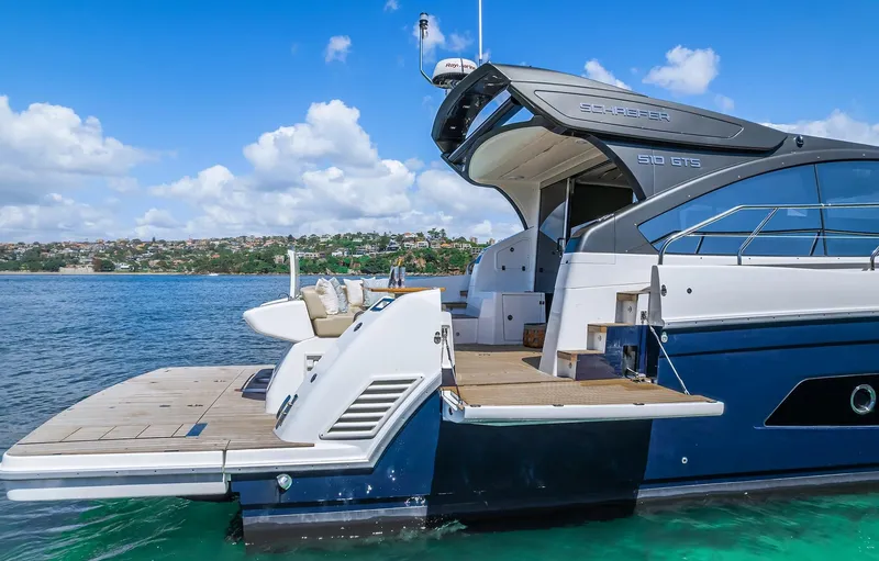 Slide: The Image of 2025 Schaefer 510 Sport yacht docked on clear blue water. - 10