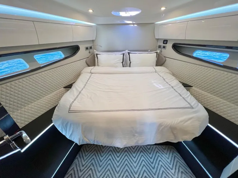 Slide: The Image of Luxurious cabin interior of 2025 Schaefer 510 Sport yacht with modern bedding and ambient lighting. - 23
