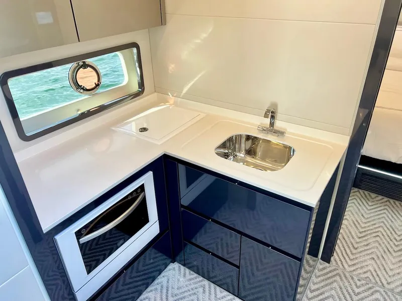 Slide: The Image of Modern kitchen area in 2025 Schaefer 510 Sport yacht with sink, oven, and window. - 29