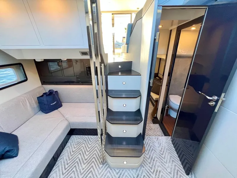 Slide: The Image of Interior of 2025 Schaefer 510 Sport yacht with modern design and cozy seating area. - 34